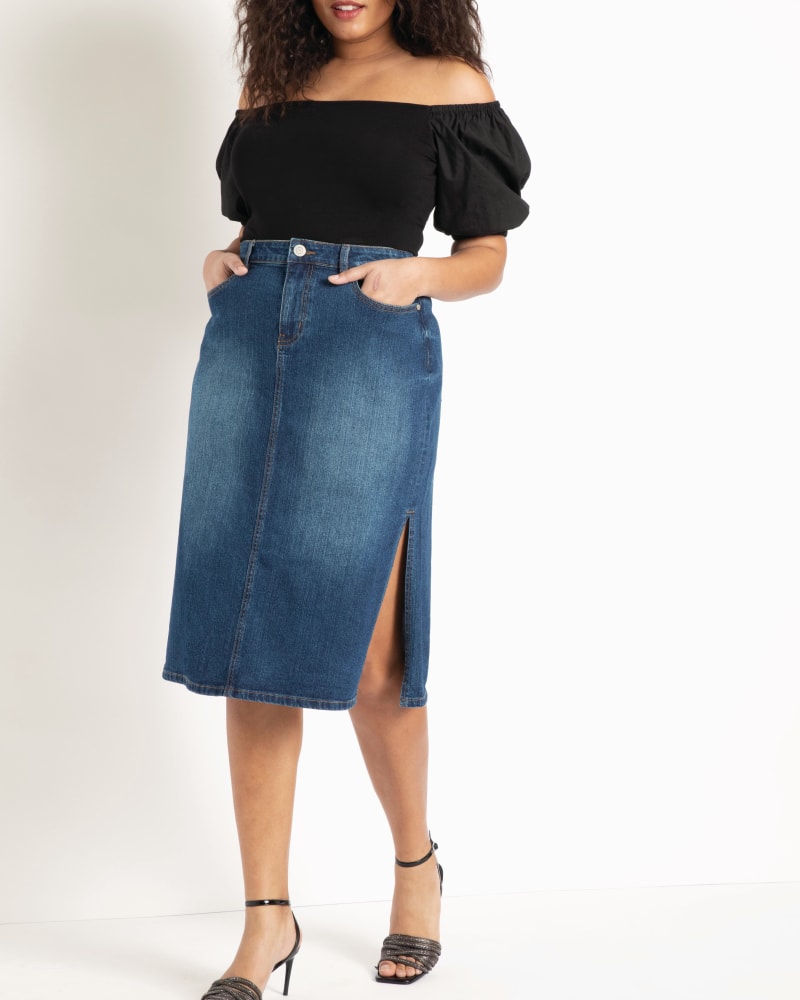 Front of a model wearing a size 14 Denim Midi Skirt with Side Slits in Medium Wash by ELOQUII. | dia_product_style_image_id:206642